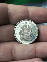 Reverse of 2017 Canada 50-cent coin showing coat of arms, date and denomination