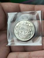 Reverse of coin showing Canadian Coat of Arms with 50 CENTS CANADA 2021 legend in plastic flip