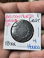 Coin reverse showing wreath and ONE CENT, in flip