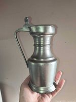 Full view of pewter pitcher showing body, handle and base