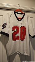 Front view showing number 28, team name, collar style