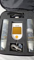 Entire kit in foam case showing control unit and two gel bottles