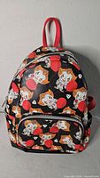 Front view of Loungefly Pennywise Balloons mini backpack showing print, front pocket and hardware