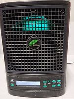 Front view of Greentech GT3000 air purifier showing grille and illuminated interior