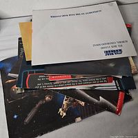 Stack of folded posters with Star Wars Insider envelope