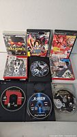 Overview of eight PlayStation video games cases and discs