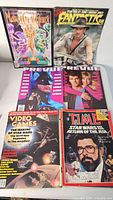 Group of six magazines laid out on table