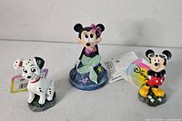 Three Disney figurines front view