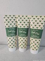 Front view of three identical hand cream tubes