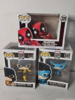 Three boxed Funko Pop figures stacked