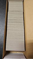 Full cardboard storage box filled with unsleeved baseball cards