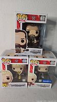 Stacked view of three Funko Pop WWE figures Elias #67, Dusty Rhodes #114, Cody Rhodes #123 Walmart Exclusive