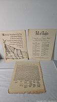 Three reproduction U.S. document prints laid out: Pledge, Bill of Rights, Declaration