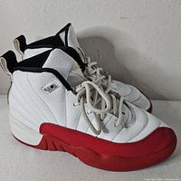 Side view showing white leather uppers, red mudguards, overall condition