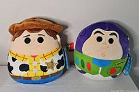 Front view of both Woody and Buzz Lightyear 8" Squishmallows with tags