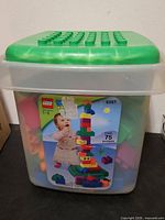 Front view of LEGO Duplo tub showing label, set number 5357, age range 1-3, and green studded lid