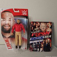 Sealed Bray Wyatt figure next to RAW & SmackDown 2014 DVD set