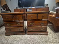 Front view pair of walnut nightstands showing drawer arrangement and hardware