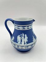 Profile view showing main relief scene and handle
