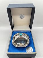 Bowl seated in original presentation box showing hallmark medallions and interior lining