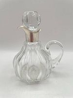 Full view of jug with stopper in place showing ribbed body and handle