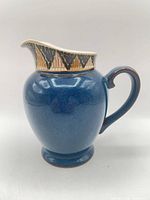 Right side profile of blue Boston Spa creamer showing spout design
