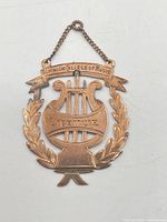 Front view showing design, inscriptions, chain