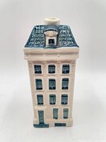 Front view of ceramic House 74 decanter showing facade and roof
