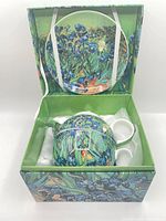 Open gift box showing saucer and packed teapot set
