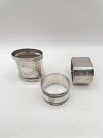 All three silver-plated napkin rings showing overall shapes