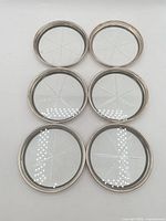 Six Birks sterling silver rimmed glass coasters front view