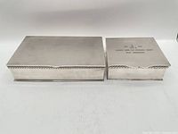 Both silver-plated boxes closed, showing size difference and exterior condition