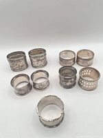 Group view of all nine silver plated napkin rings