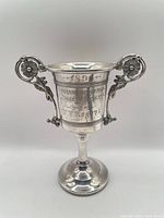 Full view of silver-plated trophy cup showing overall form and handles