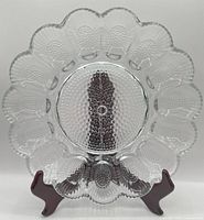 Front view of clear glass deviled egg platter on stand