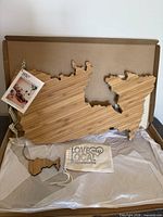 Cheeseboard, ornament and storage bag inside open box