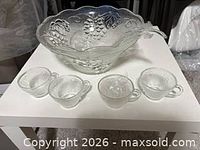 punch bowl and four of the cups displayed on table
