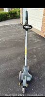 Full frontal view of Greenworks corded electric lawn edger showing entire tool