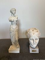 Both sculptures side by side showing relative size