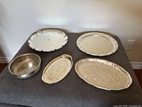 All five silver-plated serving pieces displayed together