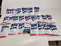 All 23 AffordTex cold packs spread out showing fronts