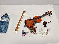 All items grouped: violin with bow, three tops, string