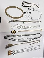All 12 necklaces laid out showing variety of styles and colors