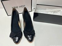Pair of black Nine West pumps with bows and box
