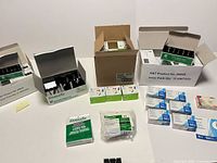 Overall lot showing binder clip boxes, push pin boxes, paper clip boxes, plastic tabs