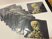 Ten sealed skull graphic mouse pads fanned out