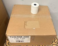 sealed cardboard case labeled THERM-200 3-1/8" x 200' with one paper roll displayed
