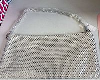 Full view of silver rhinestone Aldo shoulder bag with plastic-wrapped chain strap and brand tag