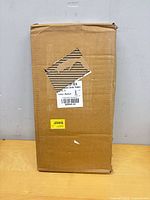Sealed carton containing the C-shaped side table