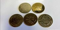 Five Olympic Trust of Canada brass tokens fronts